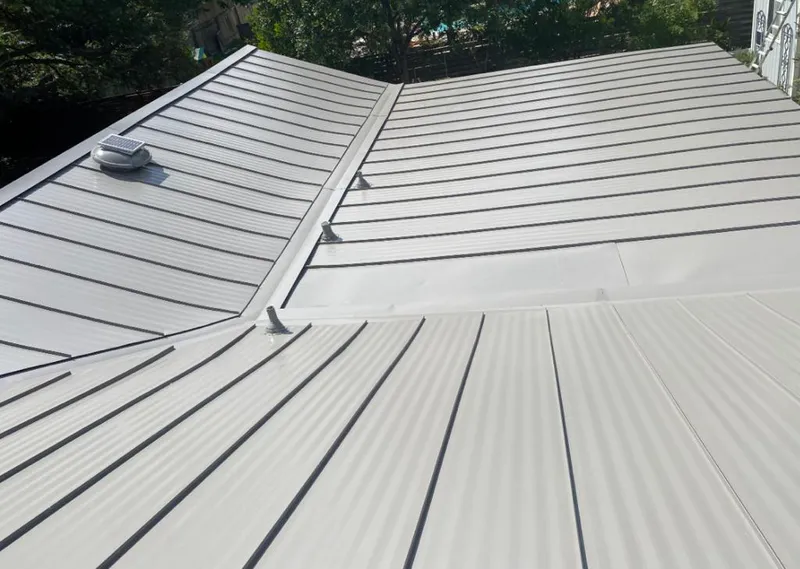 Solar attic fan installed on a metal roof for Roof Ventilation in Clarendon Hills